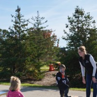 Mom and her son and daughter playing corn hole